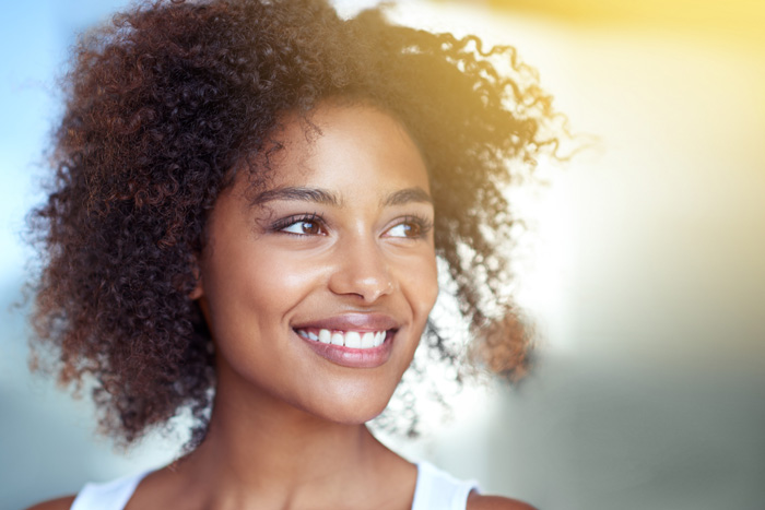 woman with beautiful skin smiling in bathroom